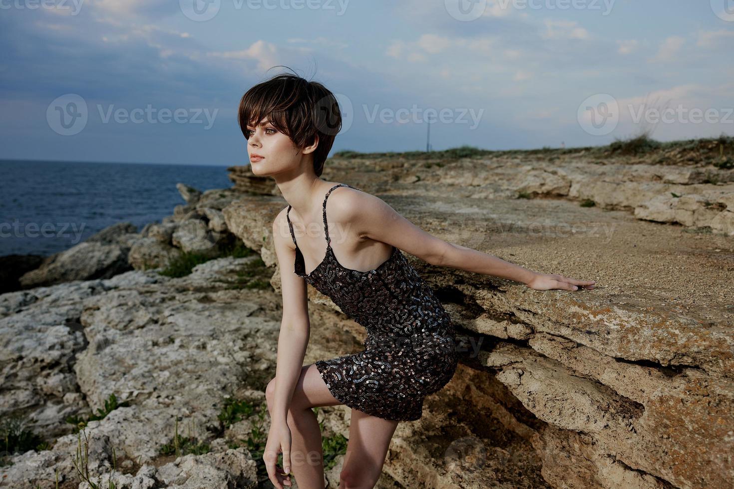 woman with makeup in dress on nature rocks landscape outdoors photo