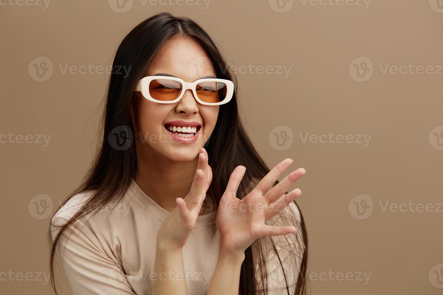 portrait woman in a beige T-shirt with glasses posing clothing fashion Green background photo