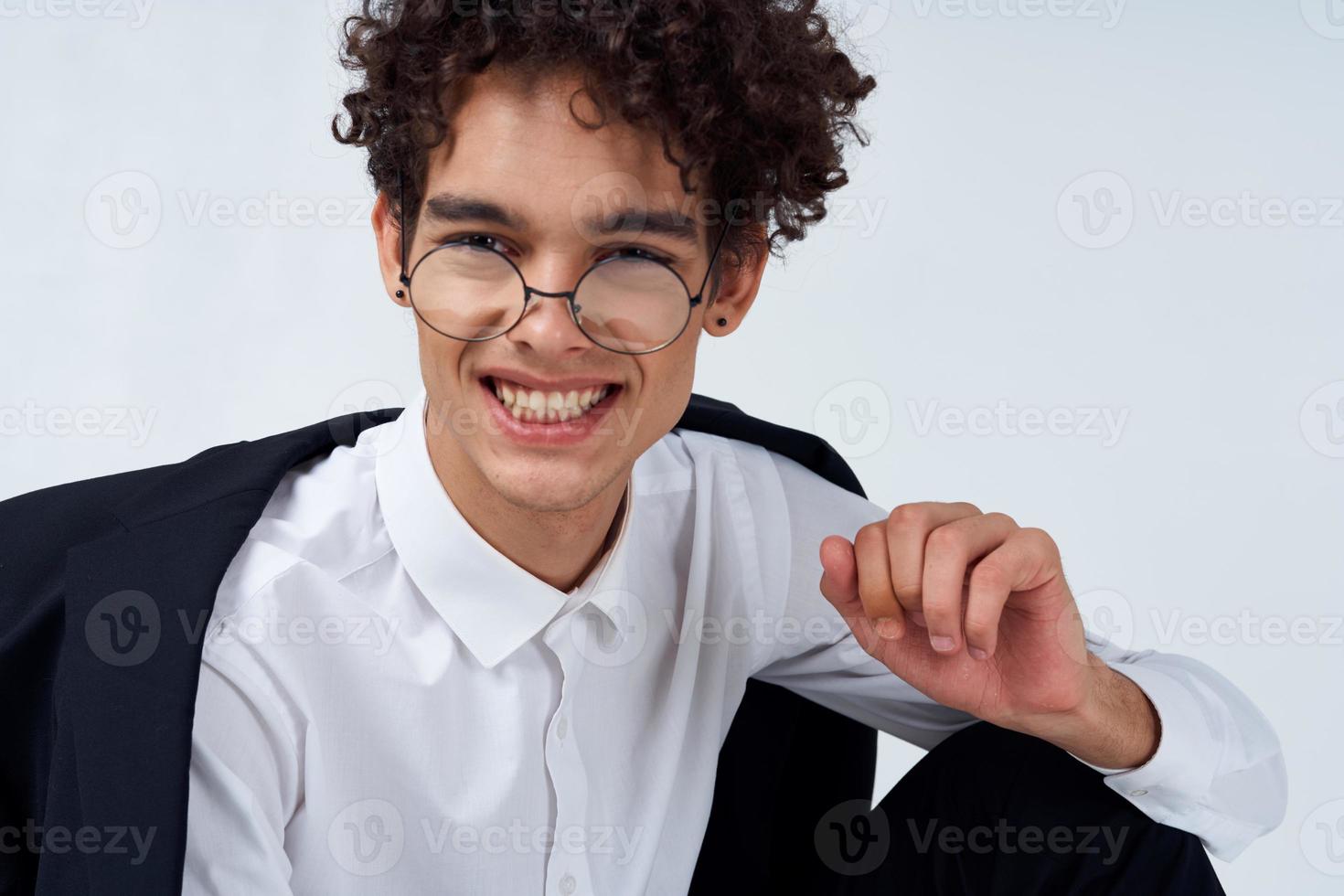 guy in glasses and in a classic suit on a light background portrait close-up photo