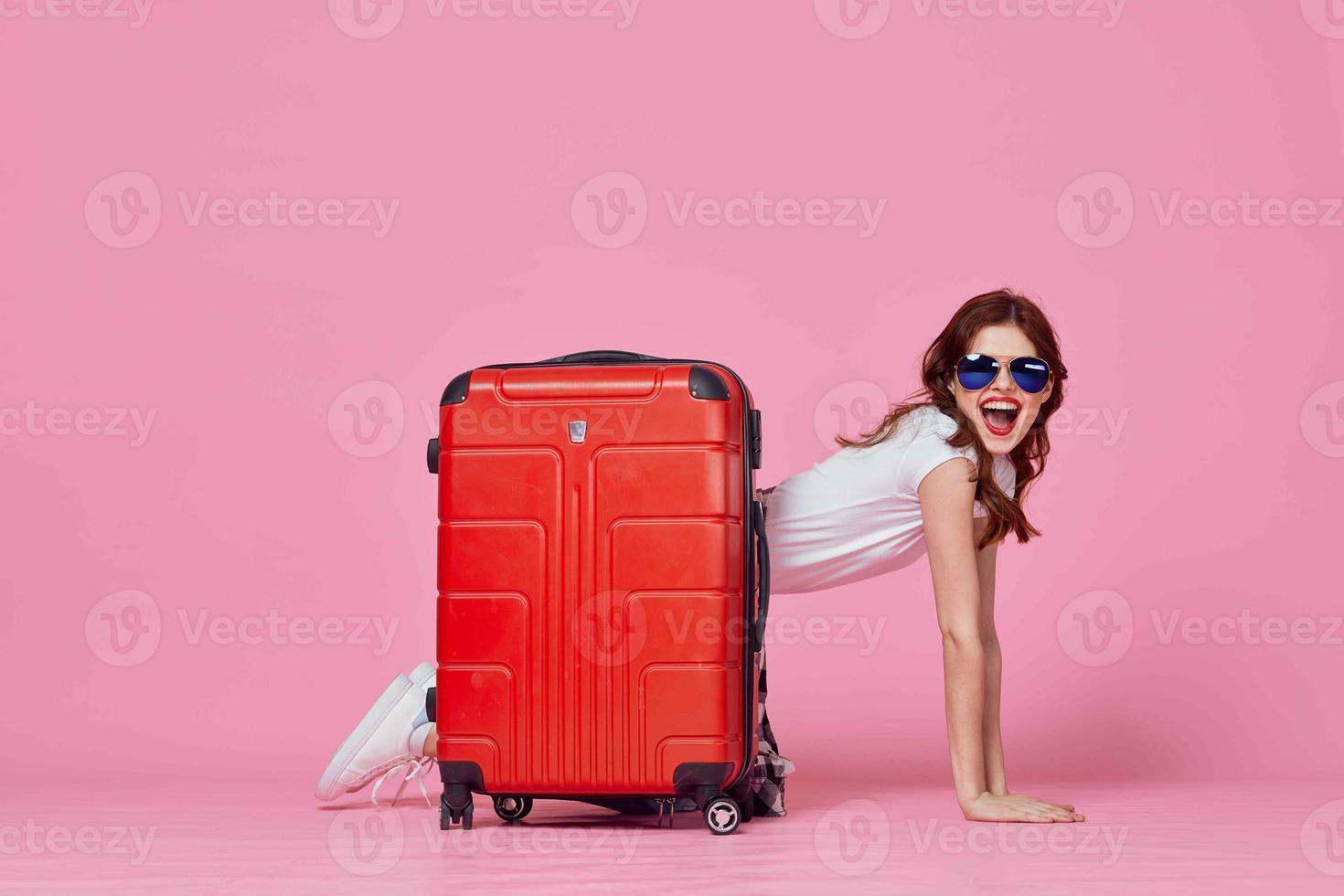 woman tourist red suitcase passport and plane tickets pink background photo