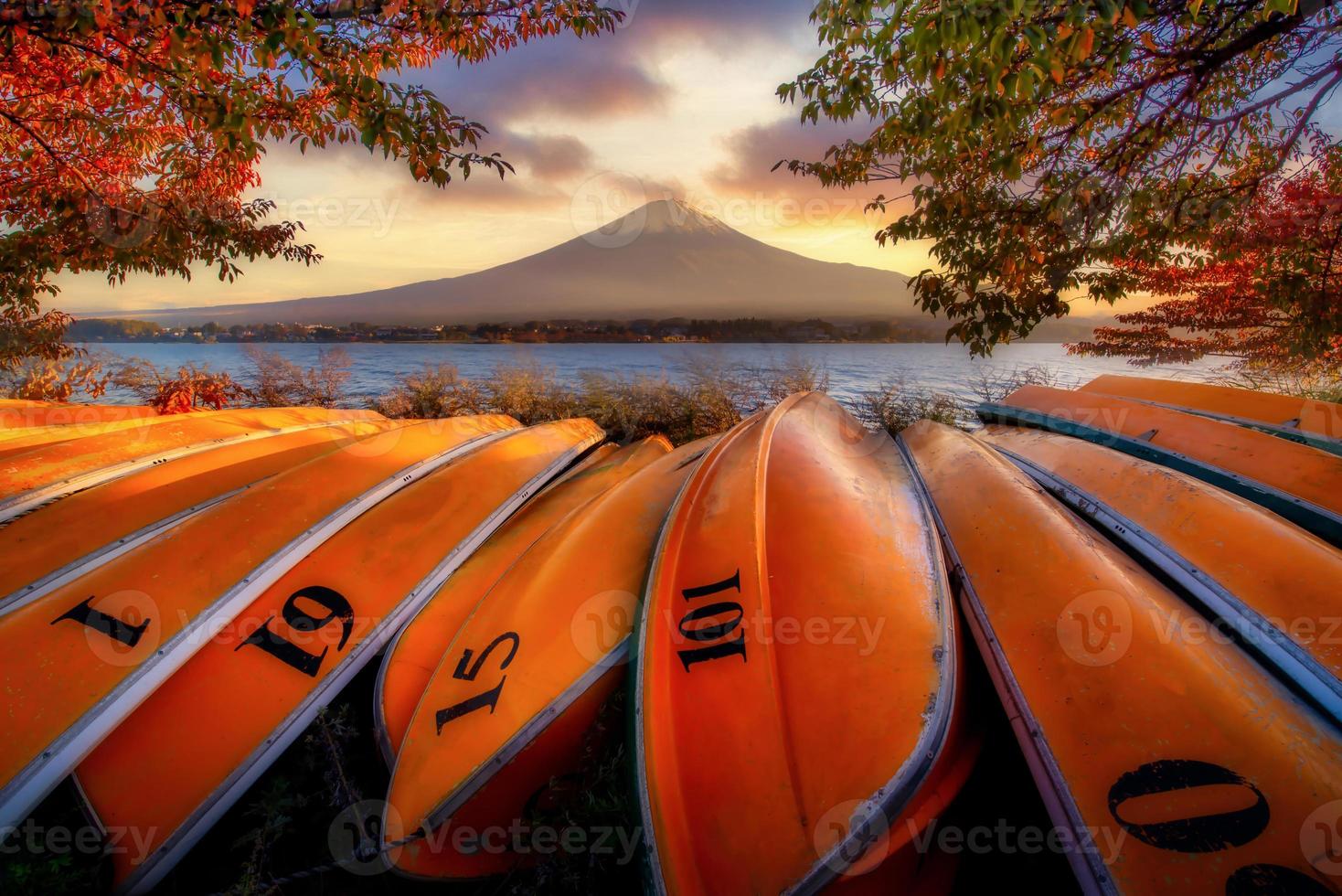 Mt. Fuji over Lake Kawaguchiko with boats at sunset in Fujikawaguchiko, Japan. photo