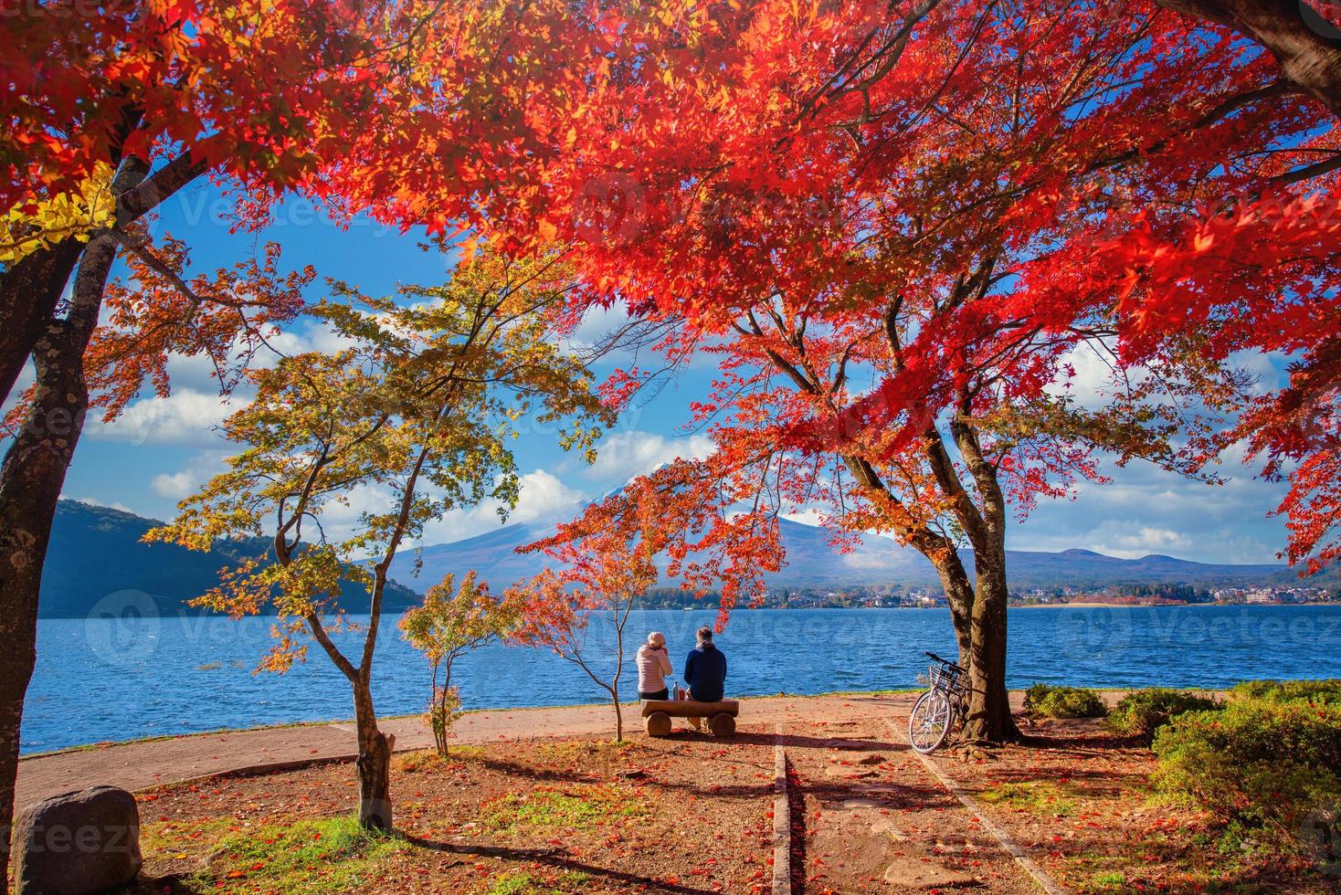 Mt. Fuji over Lake Kawaguchiko with autumn foliage and couple love at sunrise in Fujikawaguchiko, Japan. photo