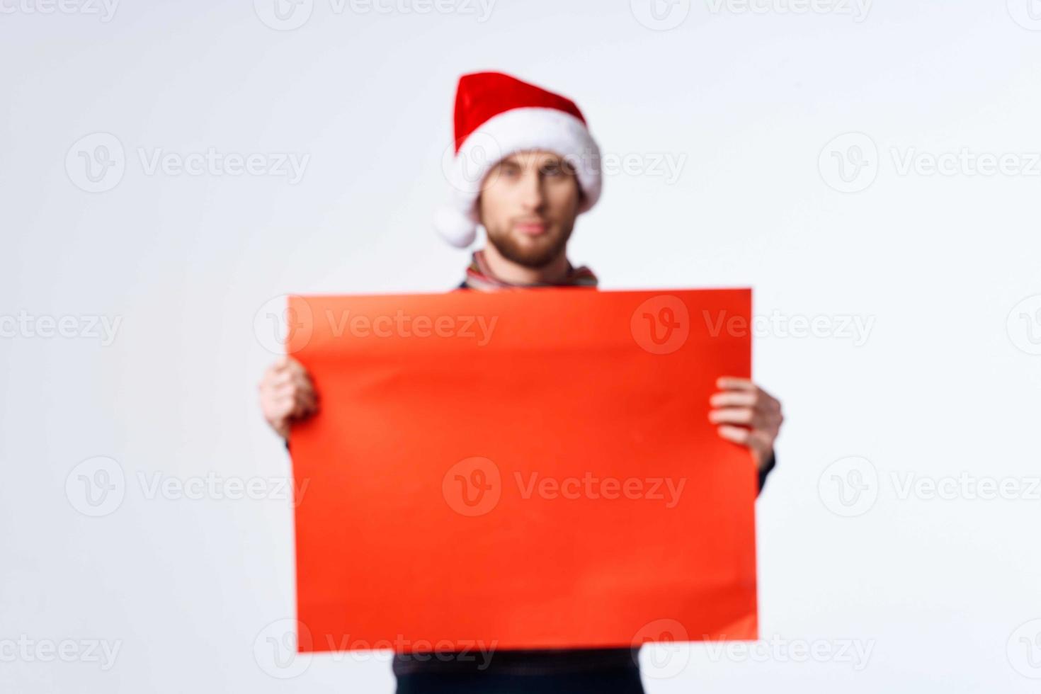 handsome man in New Year's clothes holding a banner holiday isolated background photo