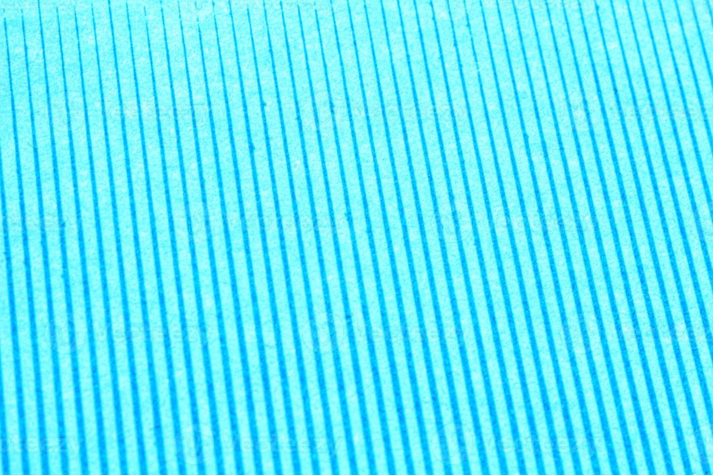 Abstract paper blue geometric symmetrical texture striped surface diagonal lines background. Structure design cardboard shape backdrop. Decoration interior concept. Flatlay, close-up photo