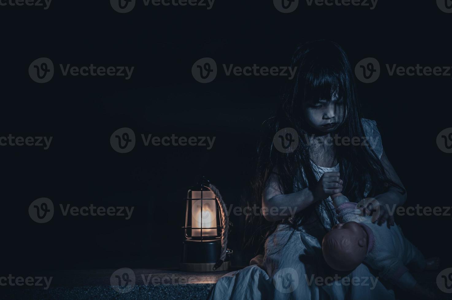 sad child ghost at night,Halloween Festival concept,Friday 13th,Horror movie scene,A girl with doll photo