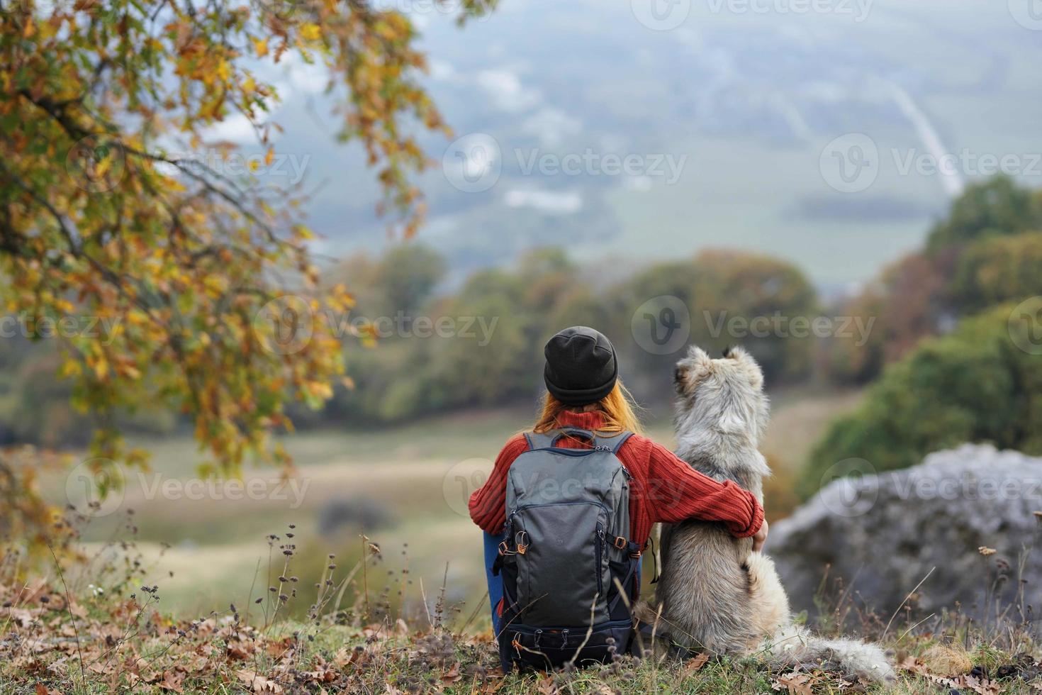 woman travels in the mountains with a dog friendship photo