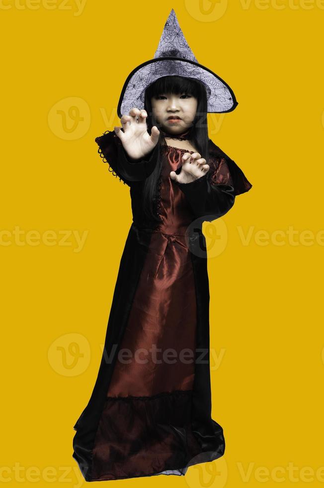 Portrait of asian little girl wear witch costume,Halloween festival concept photo