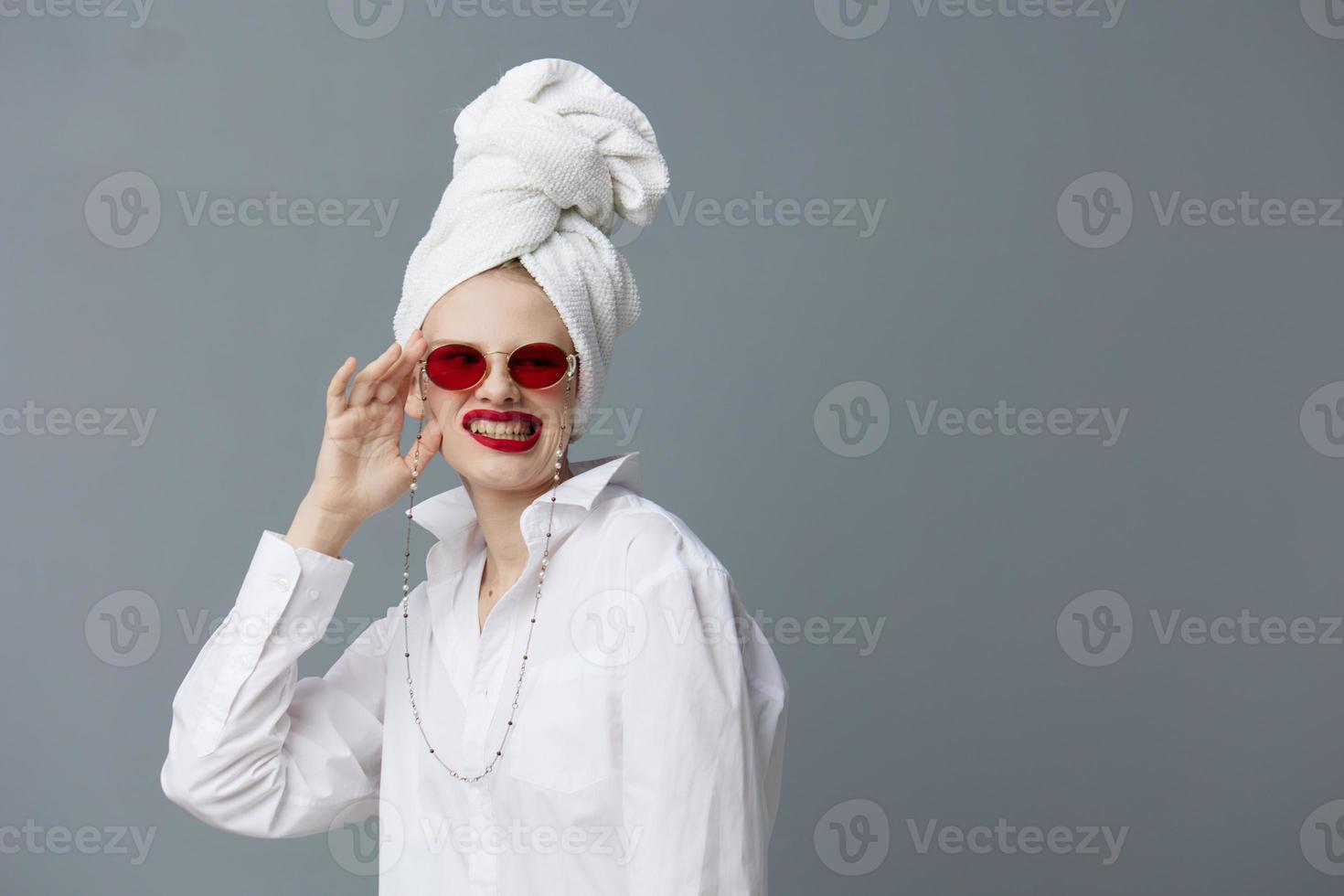 fashionable woman red glasses towel on head makeup isolated background photo