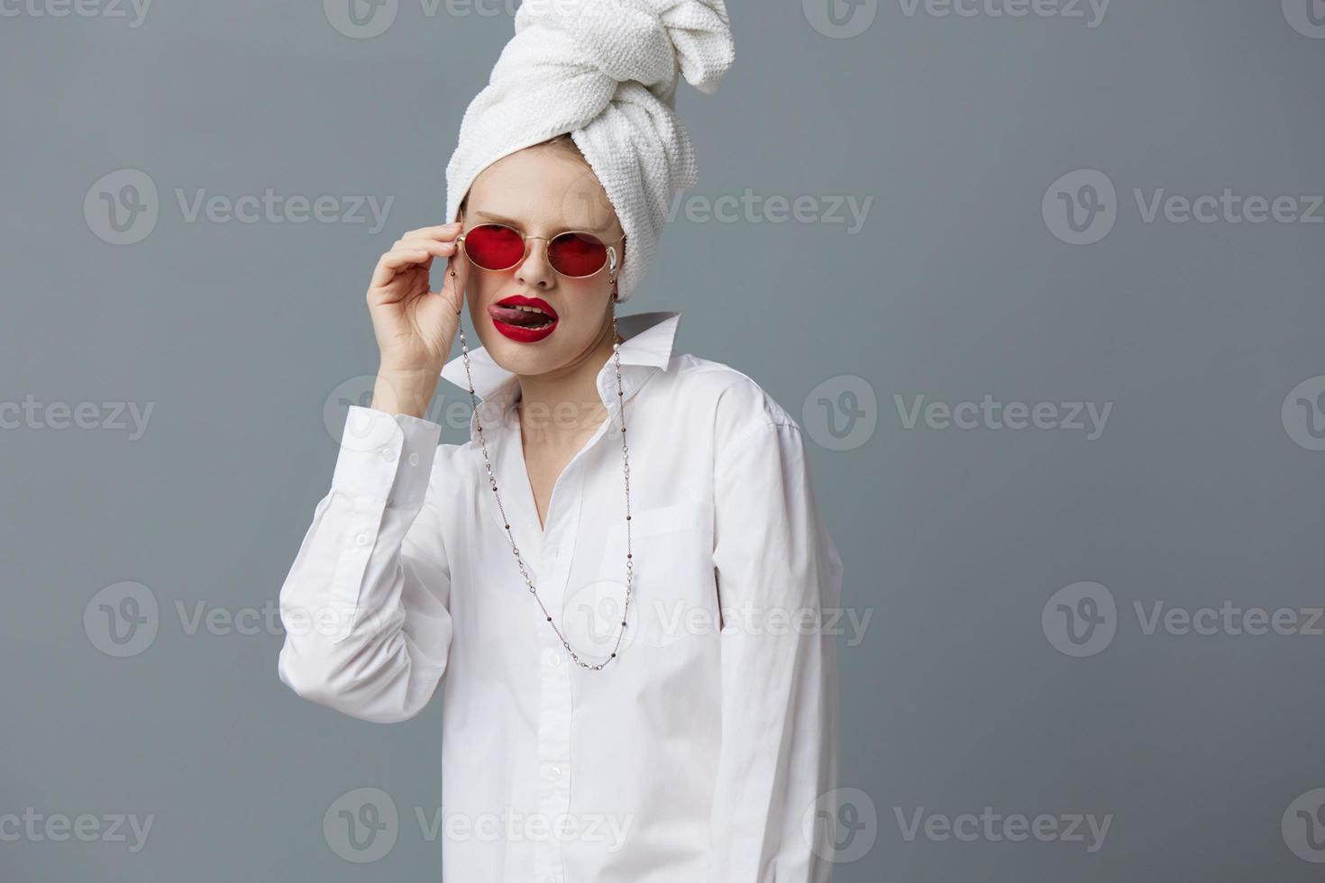 fashionable woman red glasses towel on head makeup isolated background photo