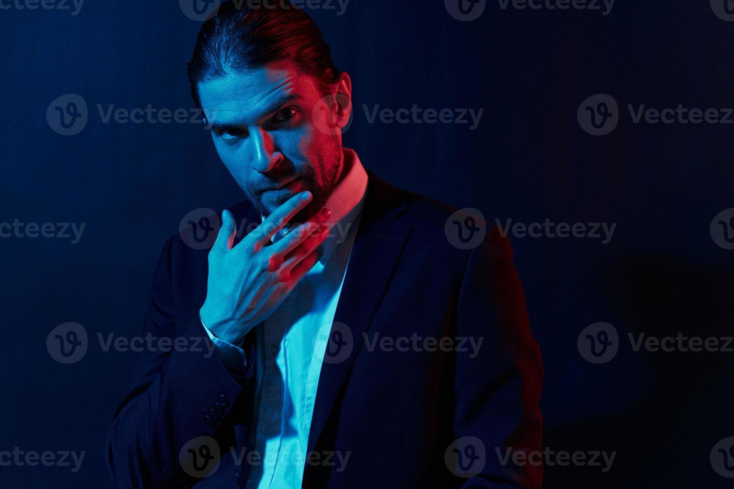 stylish man in a jacket posing self confidence dark background photo