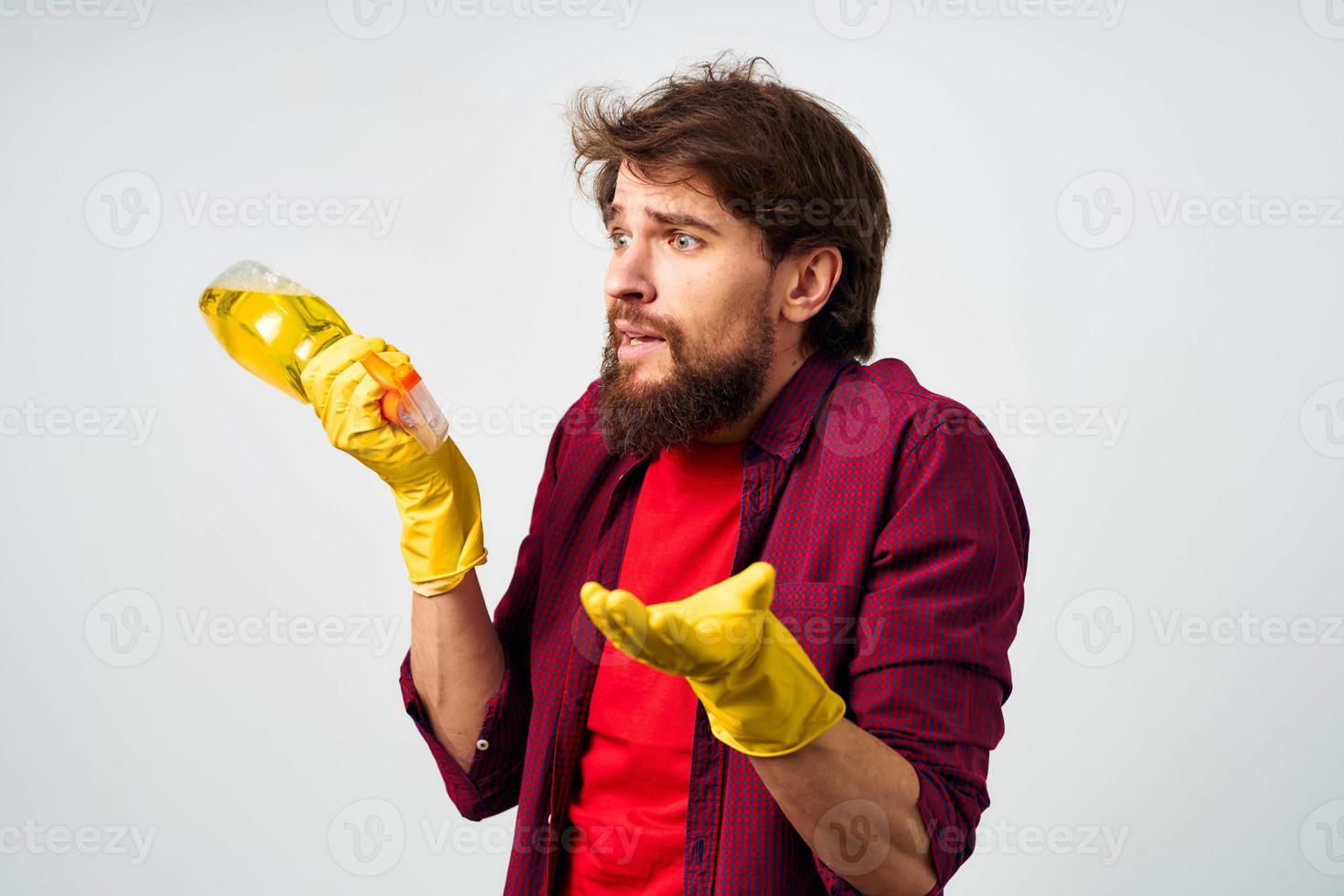 emotional man wearing rubber gloves detergent cleaning housework cropped view photo
