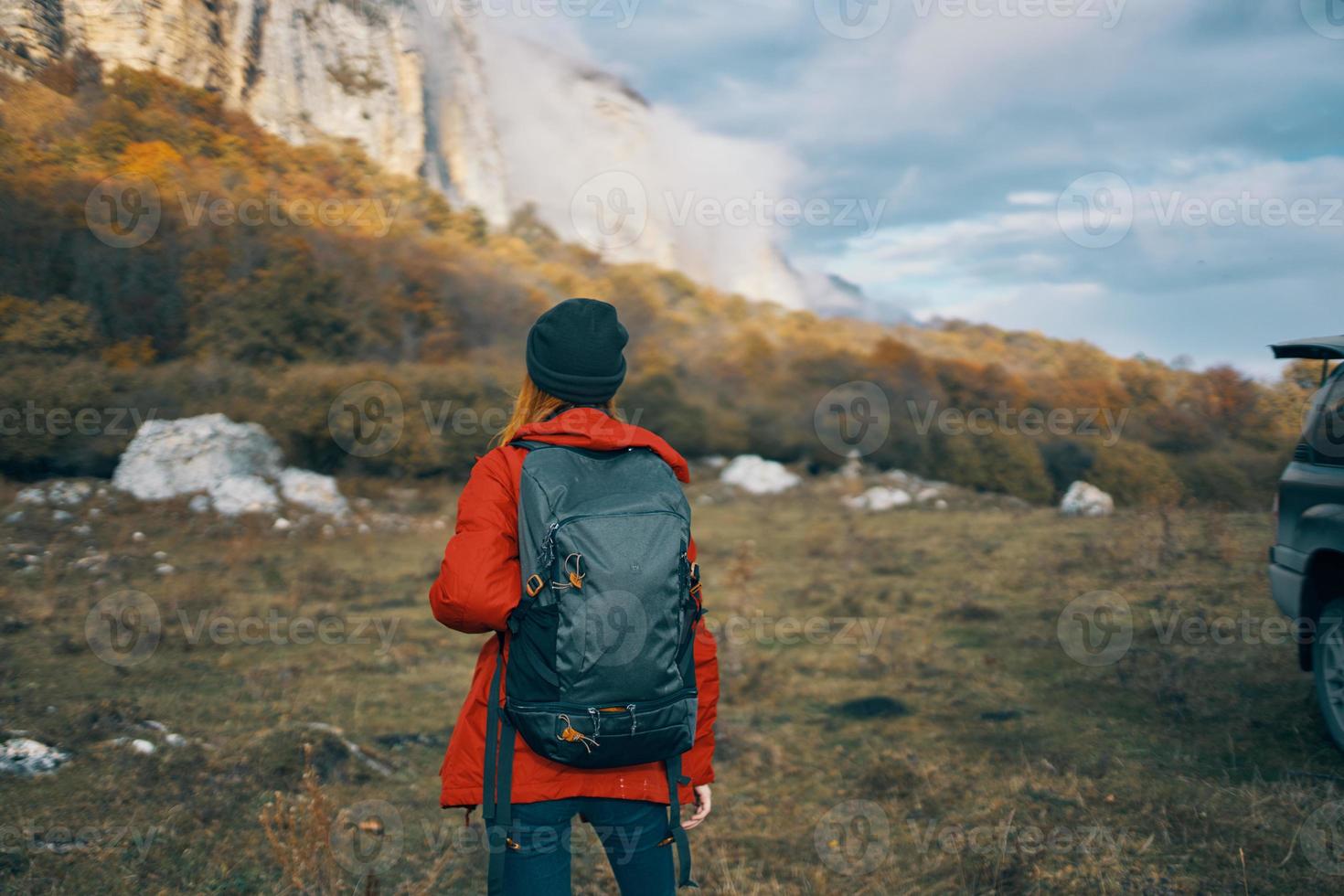 woman mountains landscape vacation backpack travel tourism hat sky clouds photo