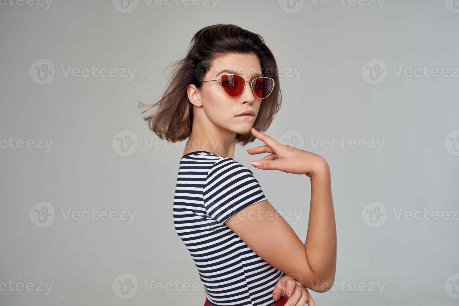 pretty woman in a striped T-shirt posing Studio photo