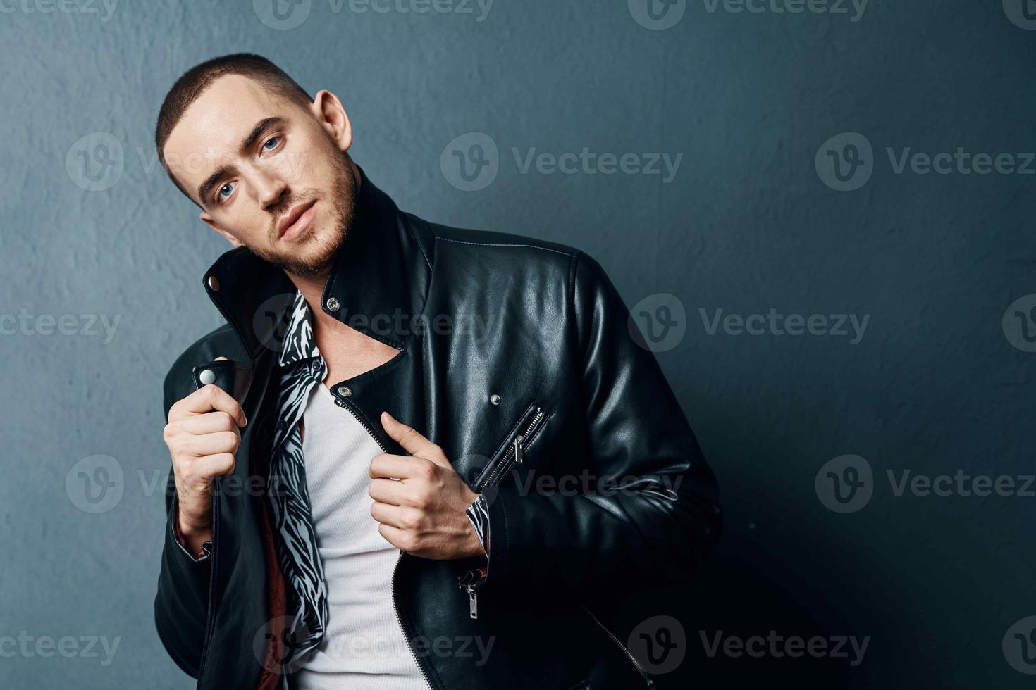 fashionable man in black leather jacket posing self confidence photo