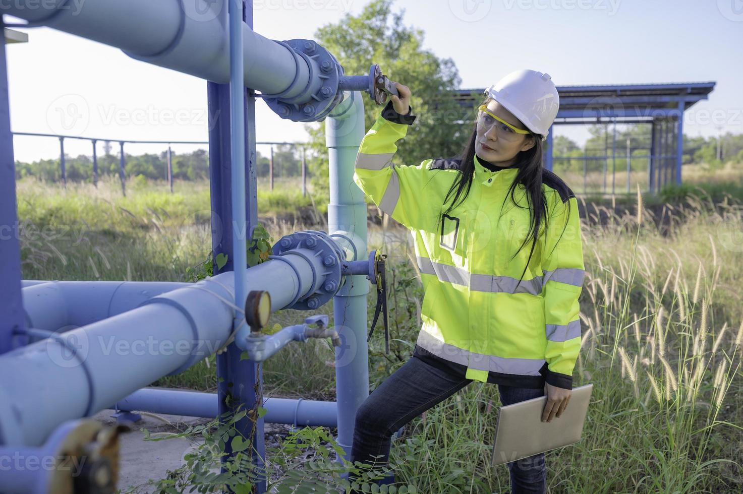 Environmental engineers work at wastewater treatment plants,Female plumber technician working at water supply photo