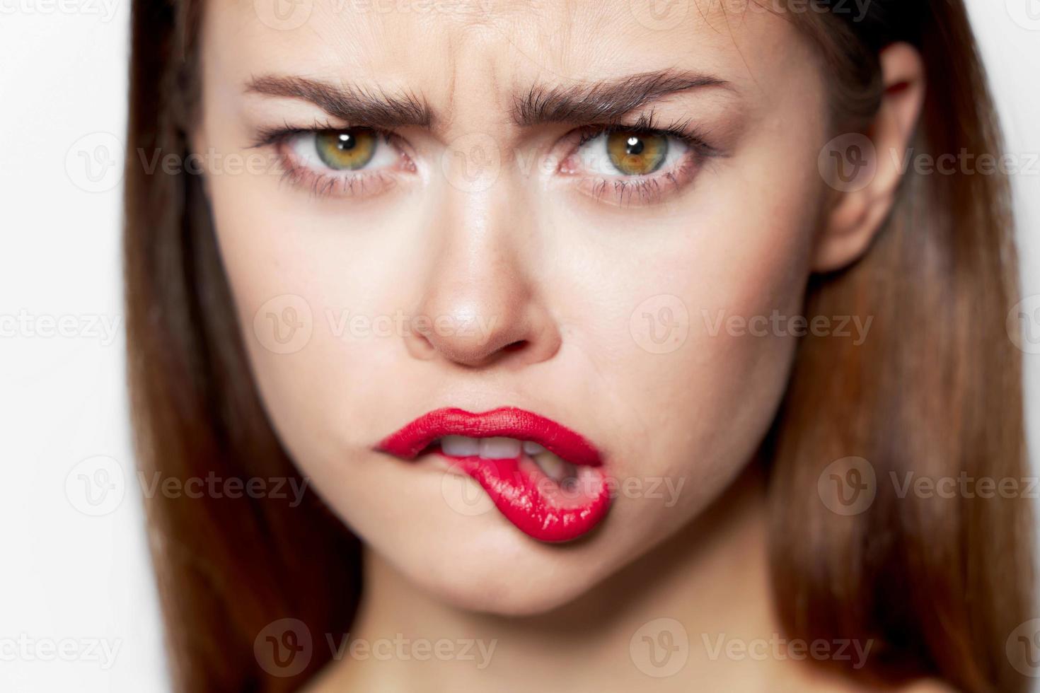 Closeup portrait of woman bites her lip charm photo