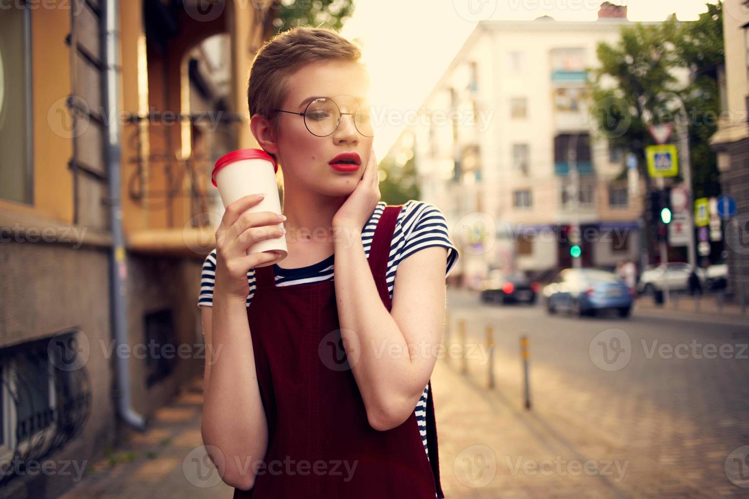 short haired woman outdoors cup with drink walk summer photo