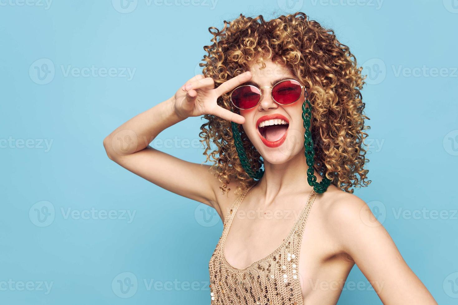 Sweet woman party on an isolated blue background, fashion sunglasses photo