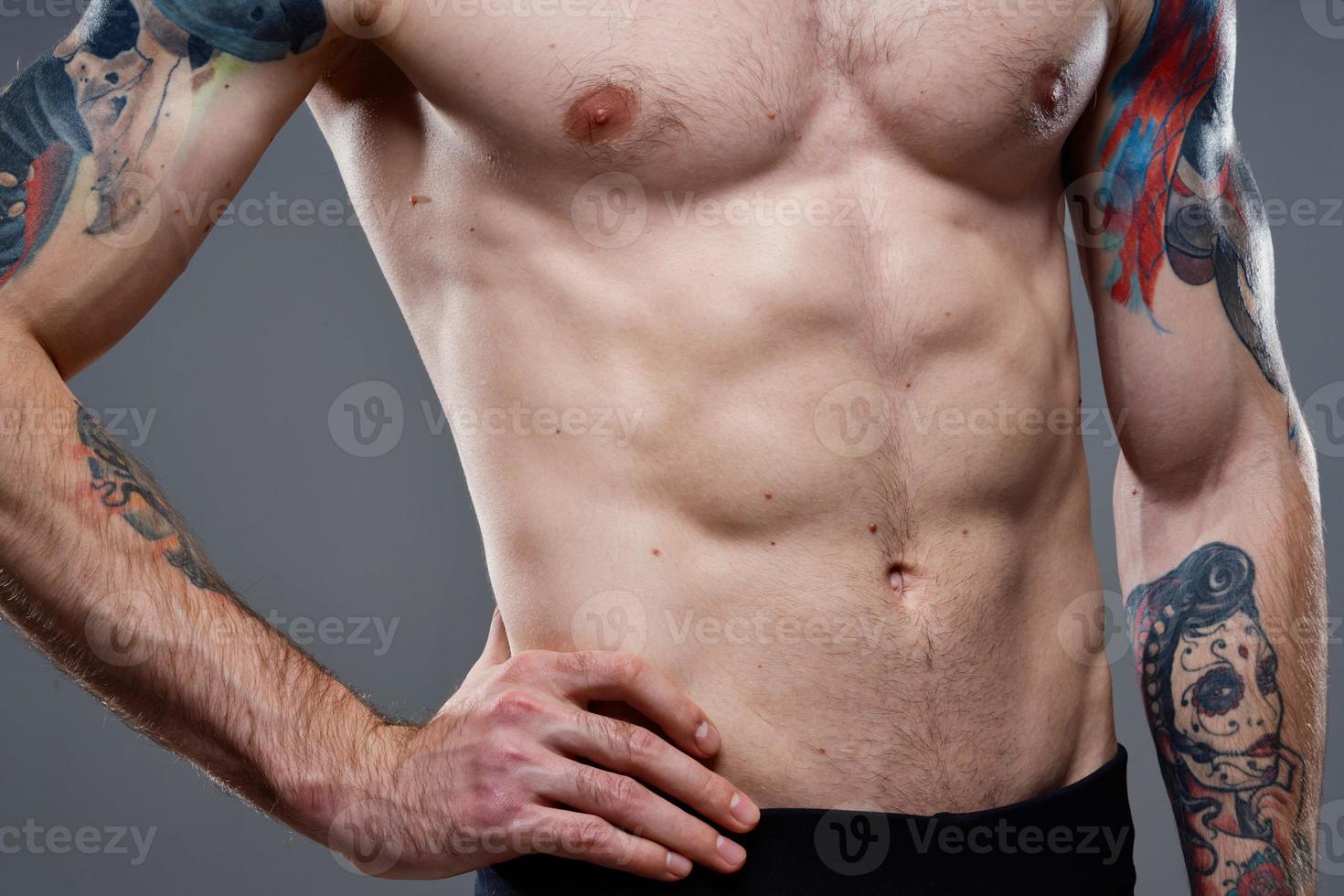 man with a pumped-up torso tattoo on his arms photo