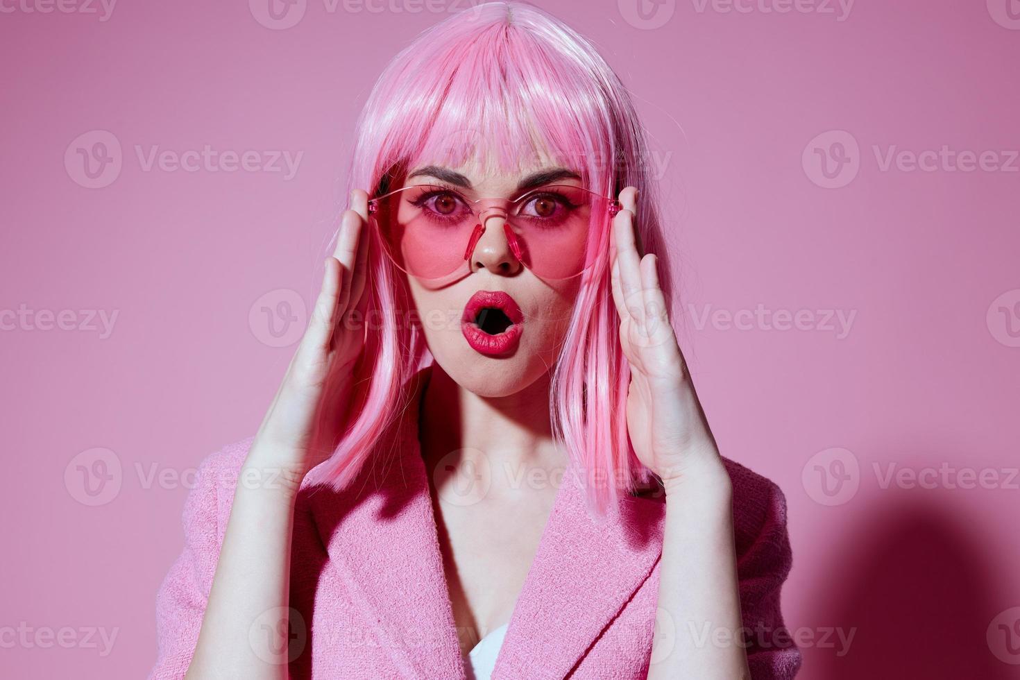 Beautiful fashionable girl gestures with his hands with a pink jacket color background unaltered photo