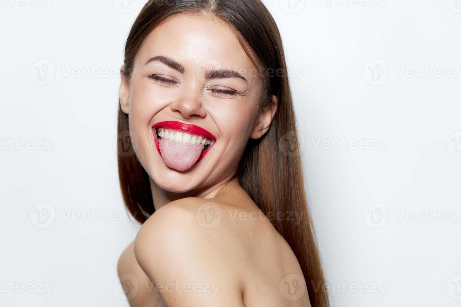 Attractive woman Bare shoulders shows tongue closed eyes smile spa treatments photo