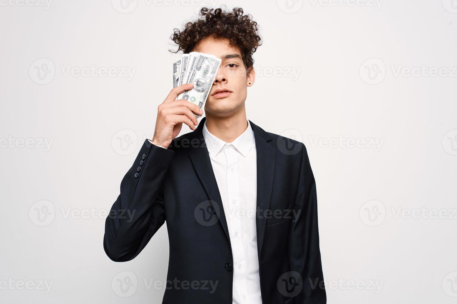man in a suit a bundle of money in the hands of a businessman self-confidence photo