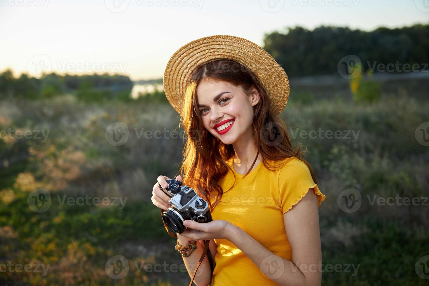 Smiling woman with camera in hands nature travel lifestyle hobby photo