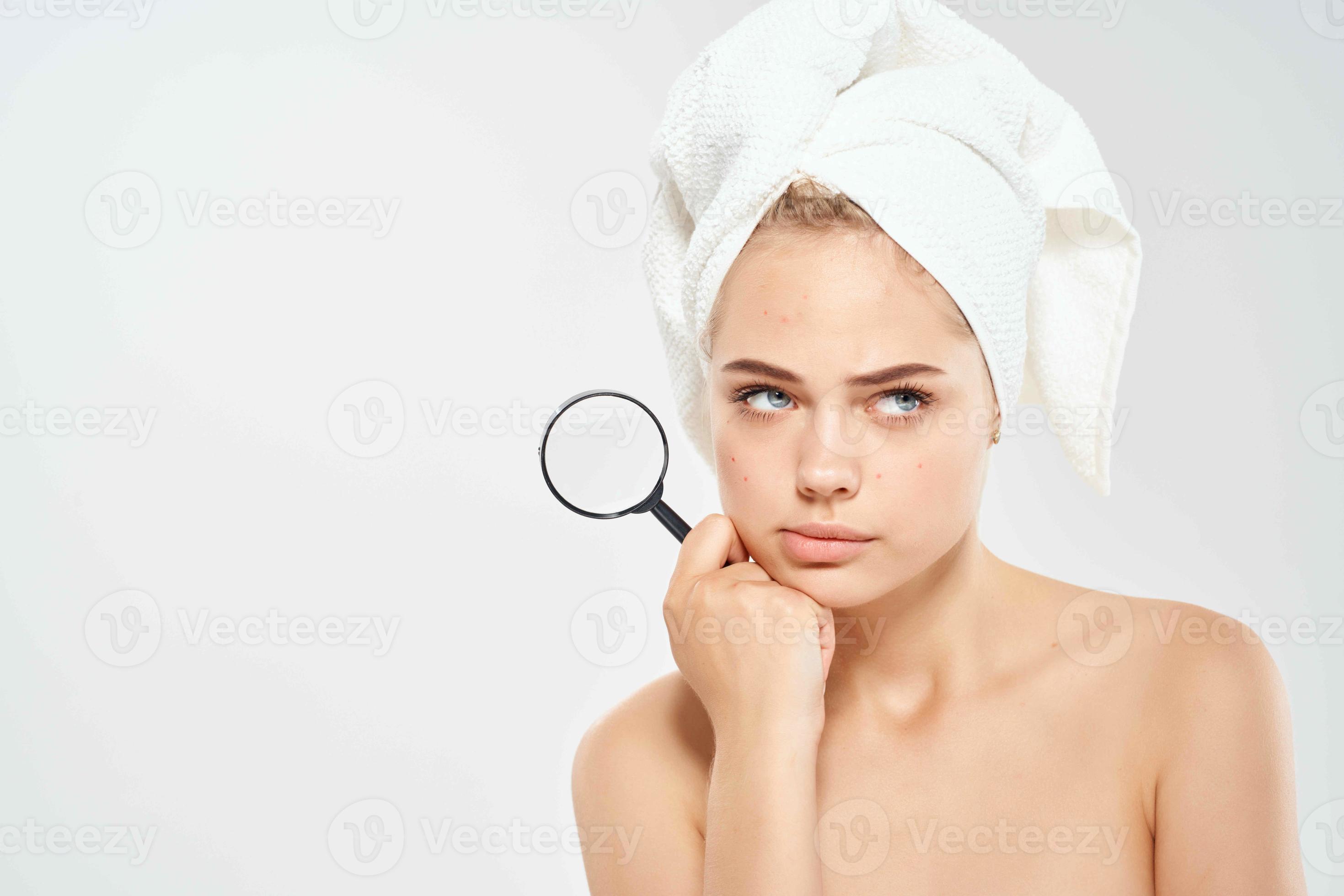 woman with bare shoulders clean skin magnifying glass in hands 21990021