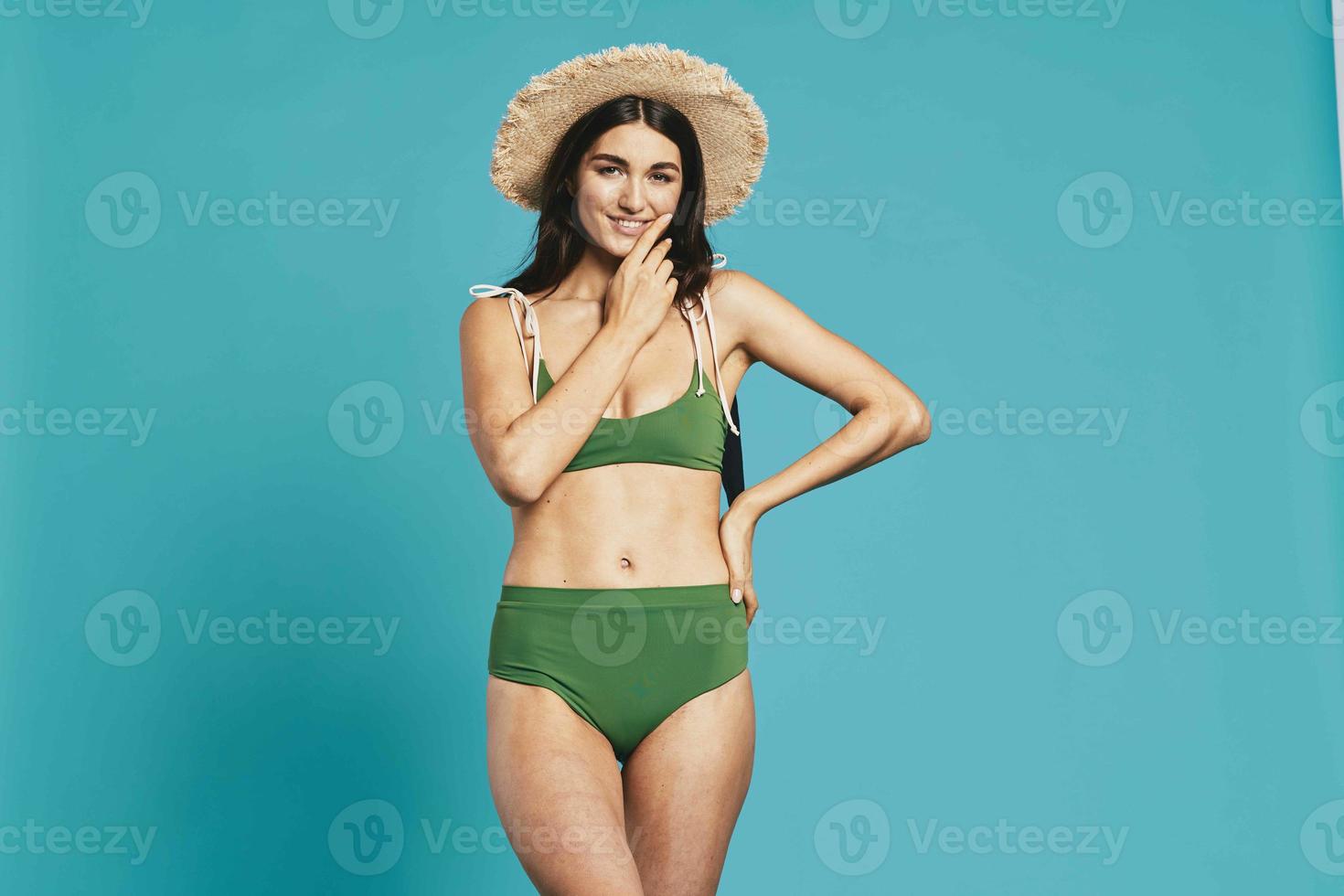 pretty woman in green swimwear beach hat posing fashion photo