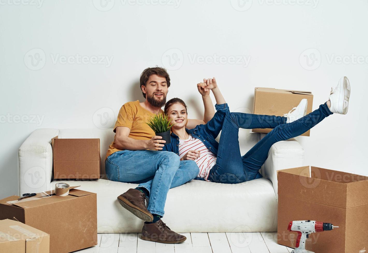 Married couple in new apartment moving boxes with joy things photo