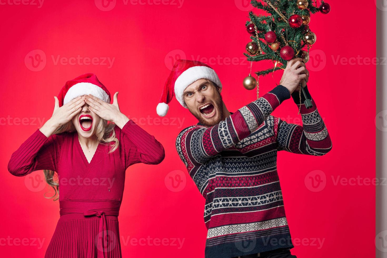 man and woman with christmas trees in hands toys decoration christmas fun photo