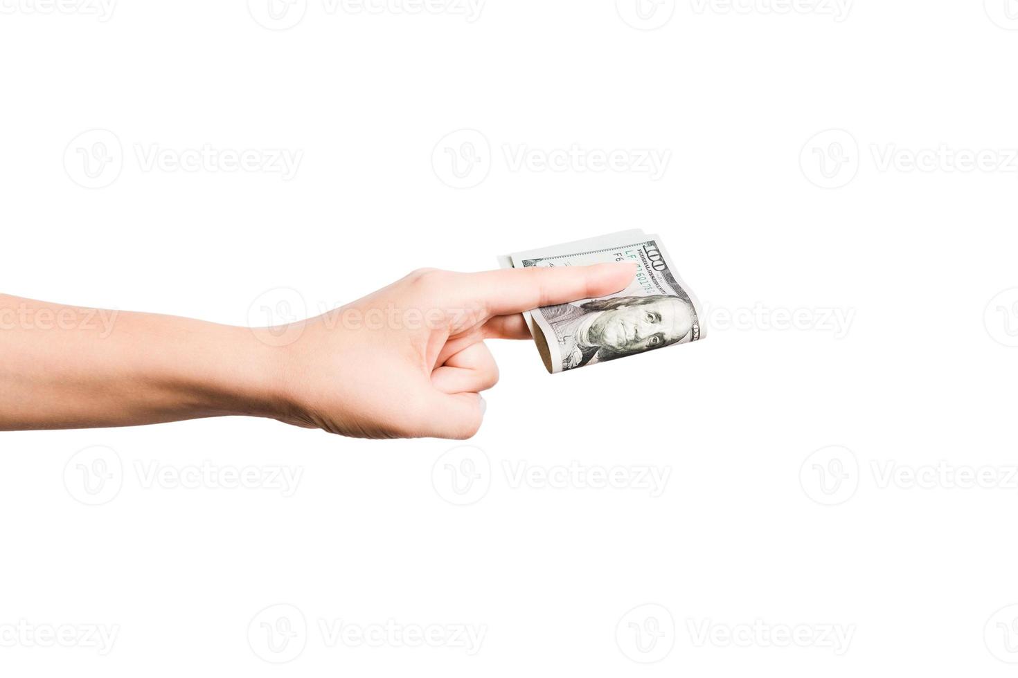 Female hand giving a bundle of dollar bills on white isolated background. Power and wealth concept photo