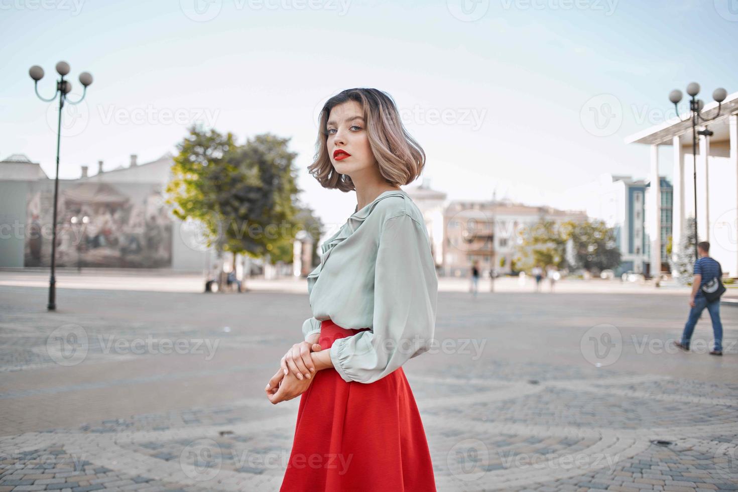 cute blonde girl in red skirt outdoors posing walk photo