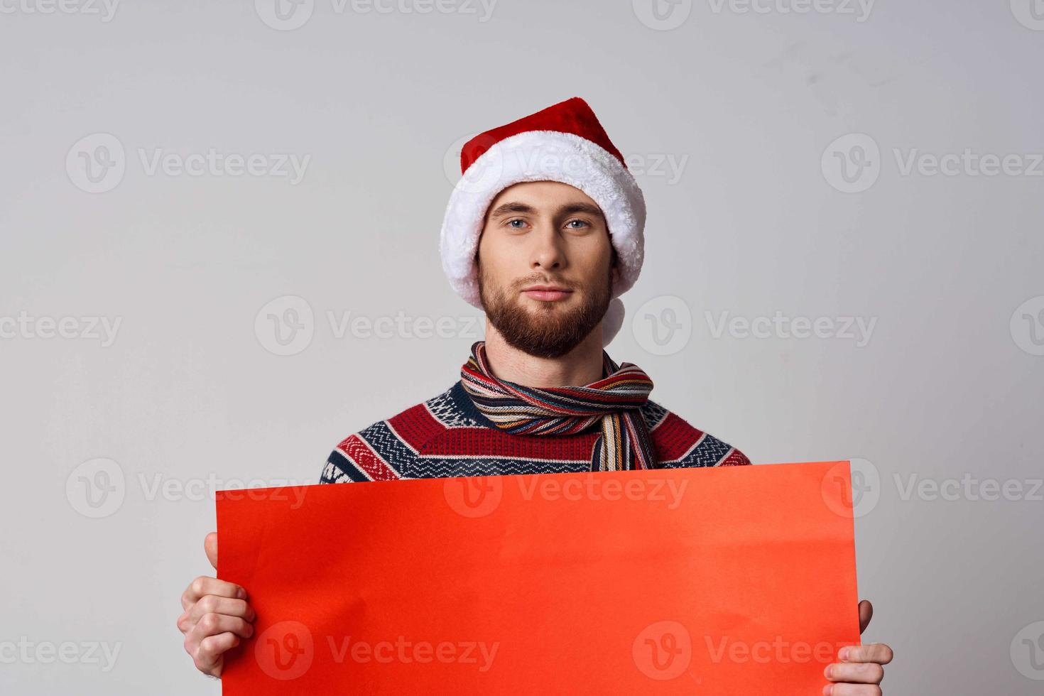 handsome man Red paper billboard advertising christmas light background photo