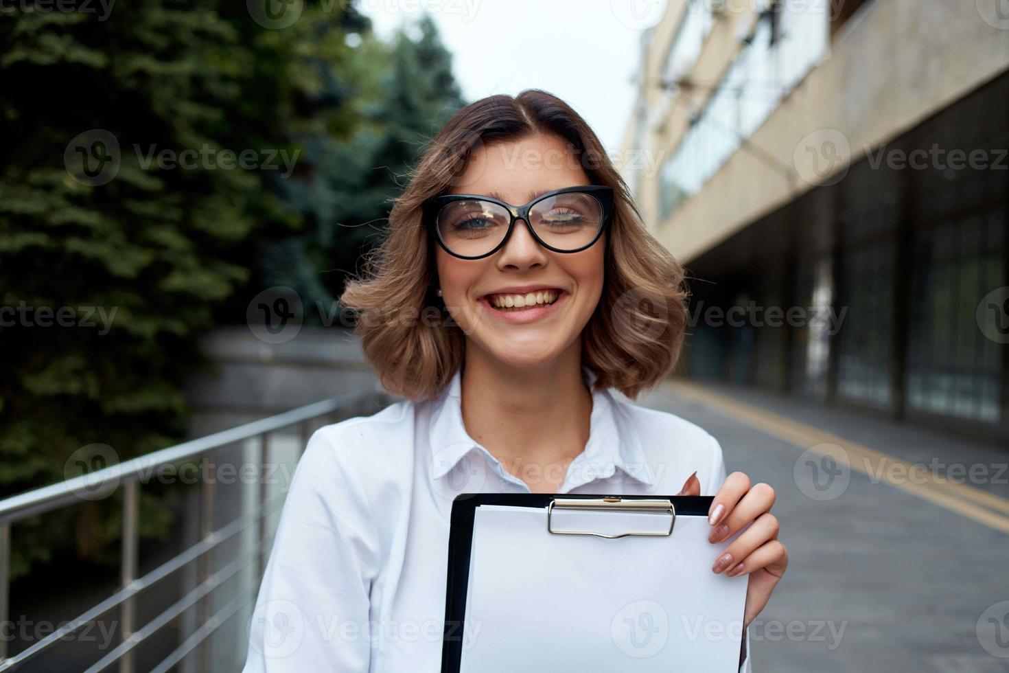 Business woman in glasses documents work on the street communication photo