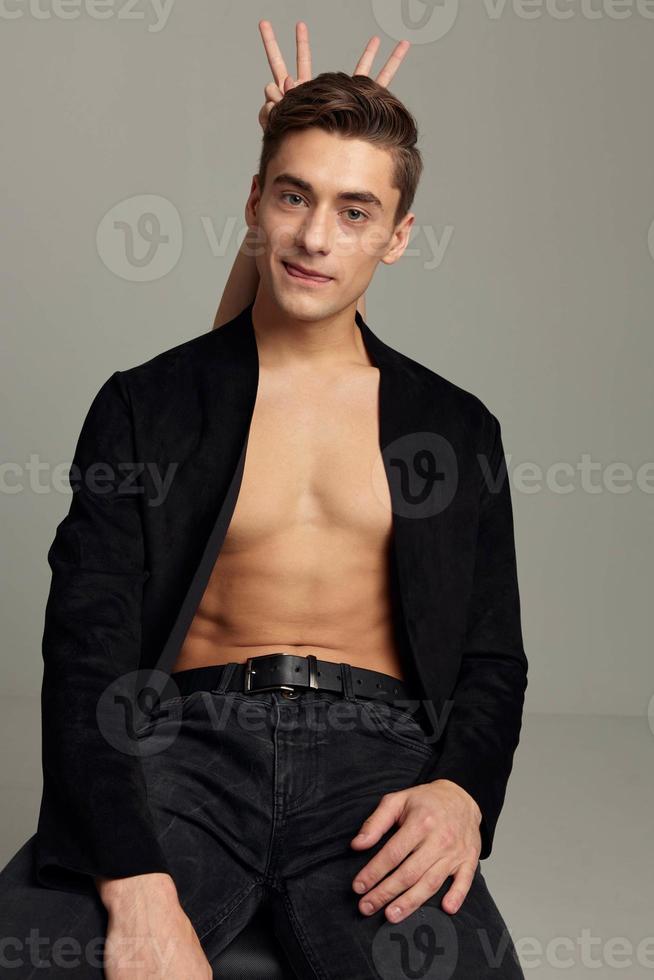 Cheerful man naked body unbuttoned shirt female fingers behind the head photo