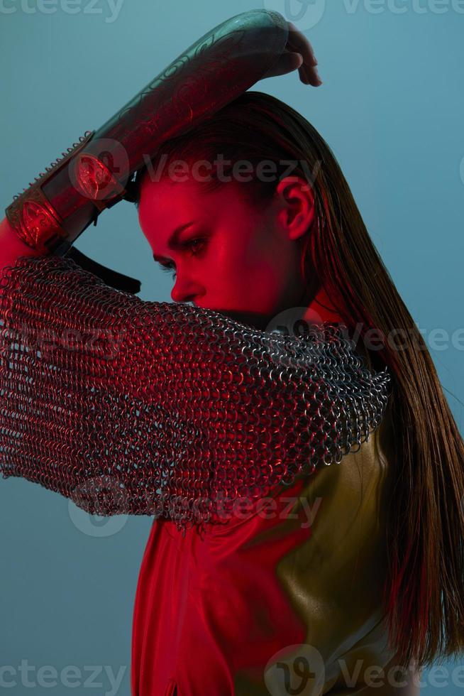 young woman Glamor posing red light metal armor on hand unaltered photo