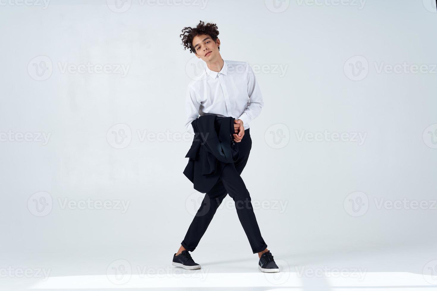 curly guy in suit jacket in hands posing lifestyle modern style photo
