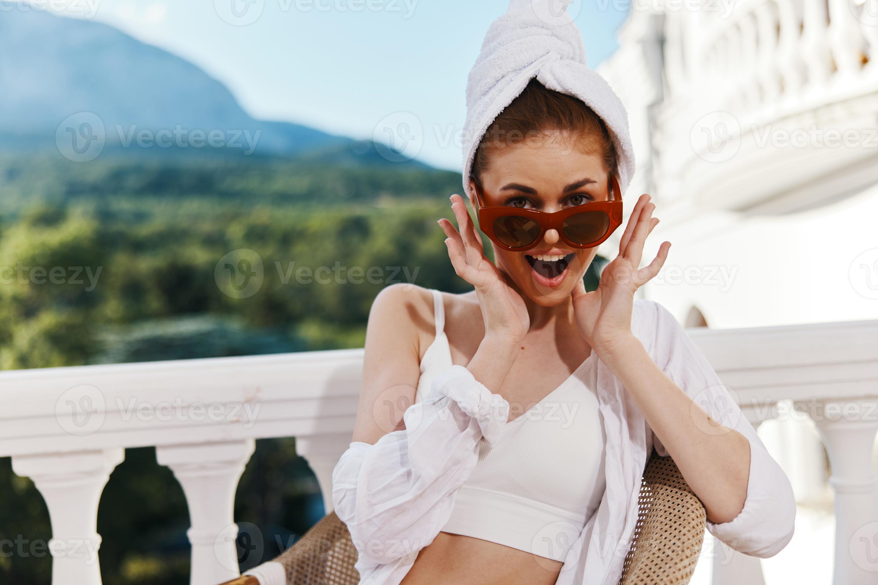 Cute girl in white robe with towel on head wearing sunglasses unaltered ...