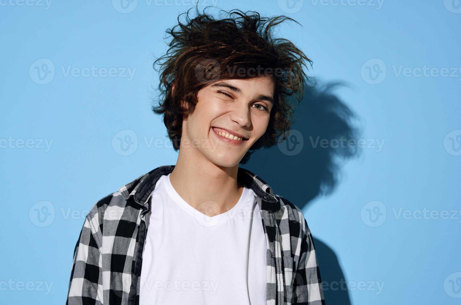 guy in plaid shirt hairstyle fashion modern style blue background photo