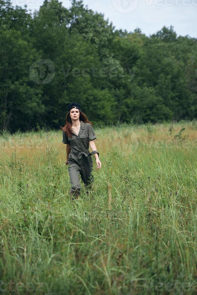 woman outdoors Travel through the meadow high grass landscape photo