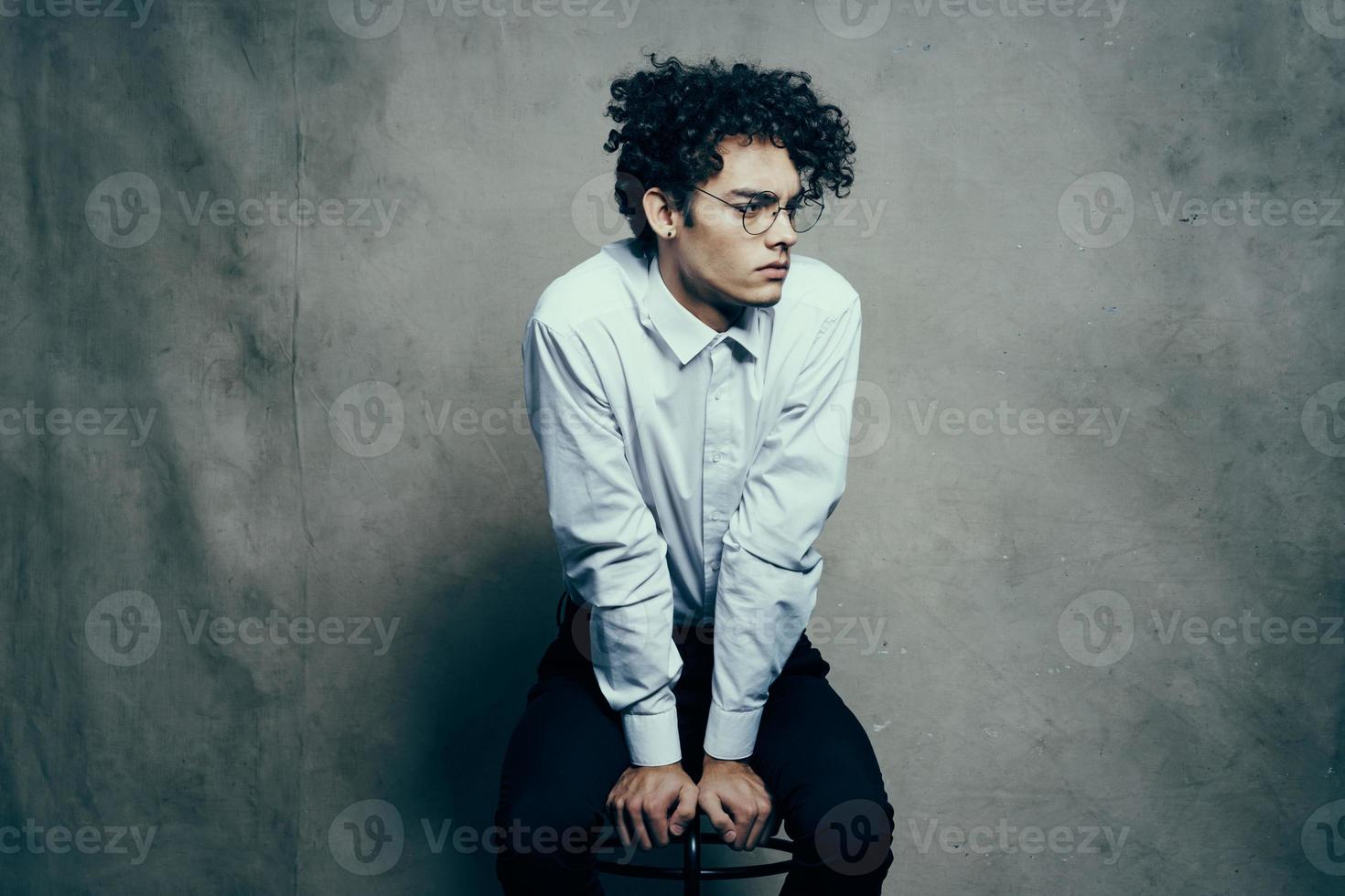 curly hair young man in shirt classic suit photography studio model on fabric background photo