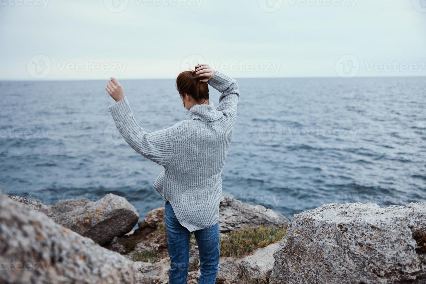 woman sweaters cloudy sea admiring nature Lifestyle back view photo
