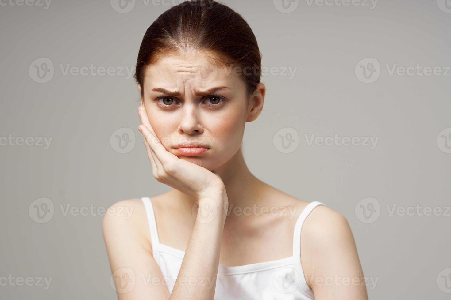 disgruntled woman dentistry dental pain close-up light background photo