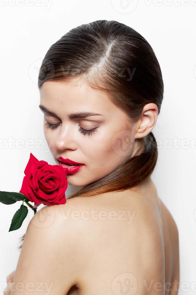 Woman with rose Closed eyes flower near lips makeup photo