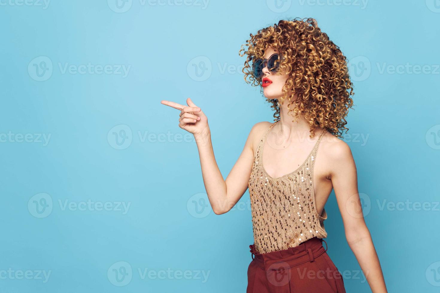 Sexy model Curly hair shows her finger to Studio Copy Space bright makeup photo