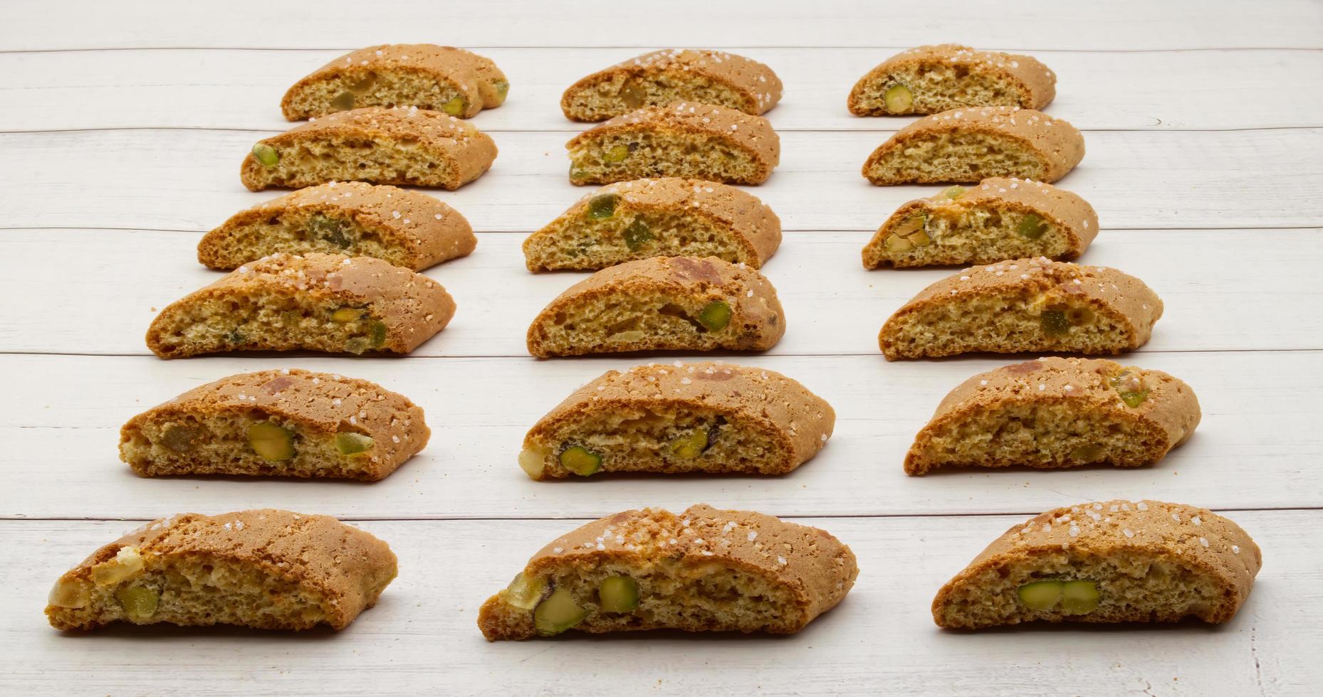 Cantucci d'Abruzzo with pistachios and citron on wooden table. photo