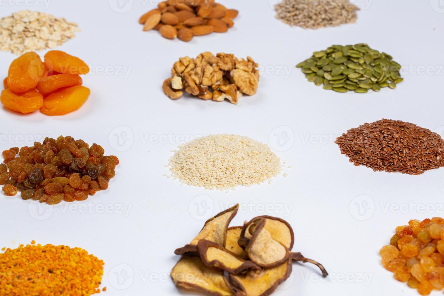 Healthy vegetarian food concept. Assortment of dried fruits, nuts and seeds on white background. Top view. photo