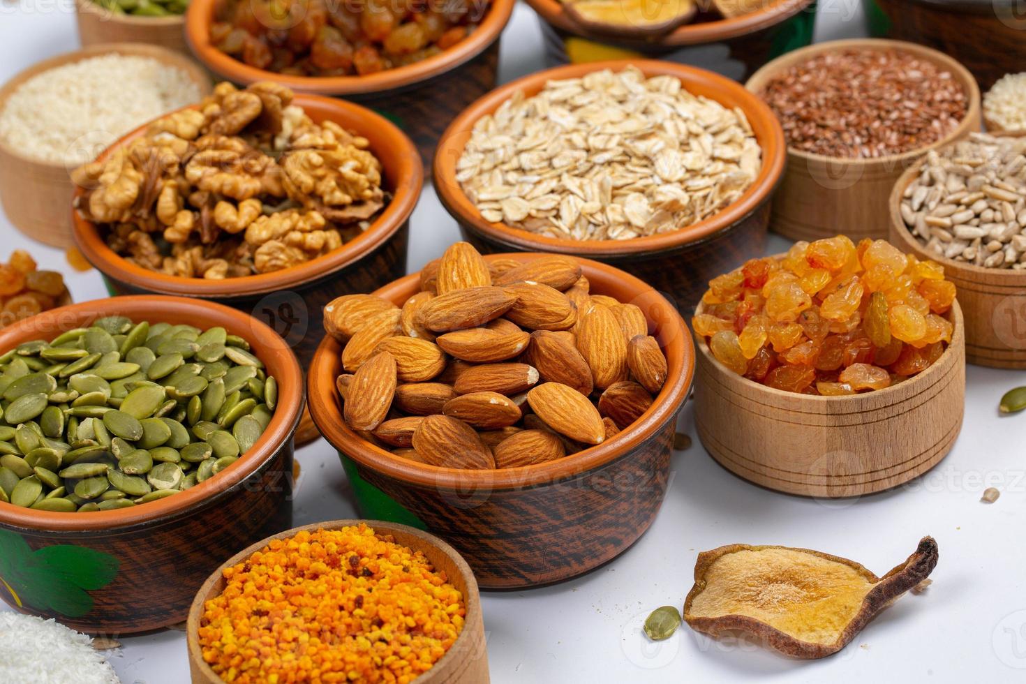 Healthy vegetarian food concept. Assortment of dried fruits, nuts and seeds on white background. Top view. photo