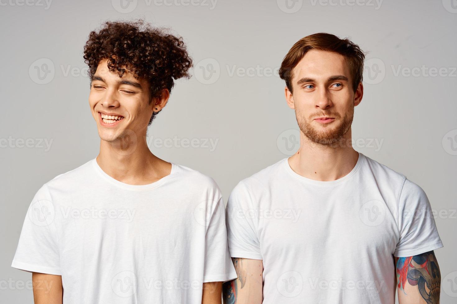two men in white t-shirts are standing next to friendship emotions photo